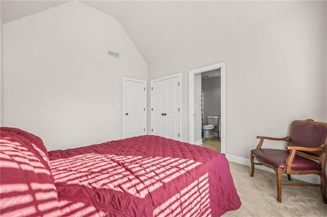 carpeted bedroom featuring visible vents, baseboards, high vaulted ceiling, and connected bathroom