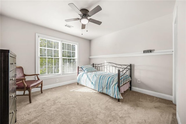 carpeted bedroom with visible vents, baseboards, and ceiling fan