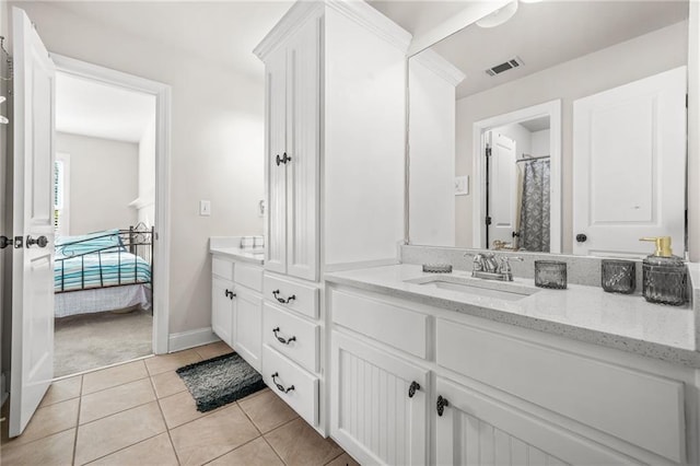 bathroom featuring tile patterned floors, visible vents, vanity, and baseboards