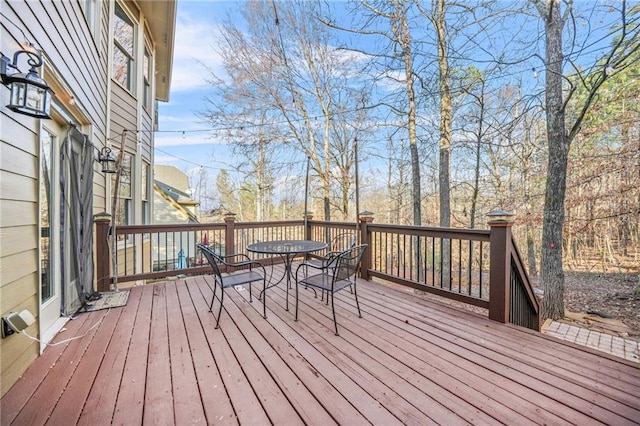 wooden deck featuring outdoor dining space