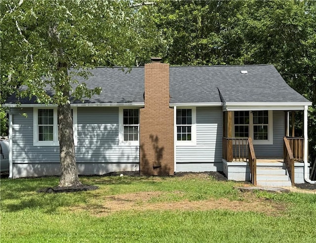 2039 Gober Ave SE, Smyrna, GA 30080 - back of house with a chimney, a lawn, a porch, and a shingled roof