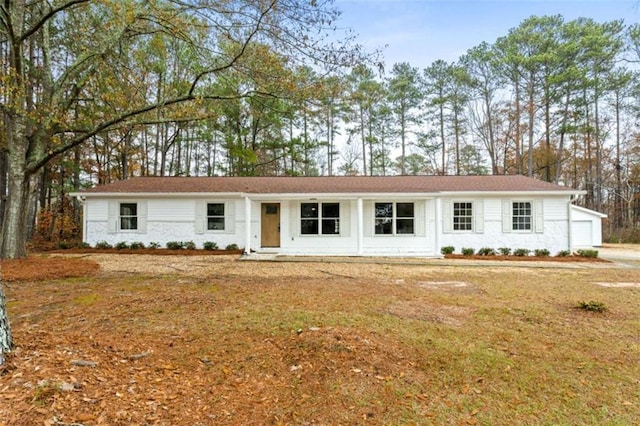 single story home with a garage and a front lawn