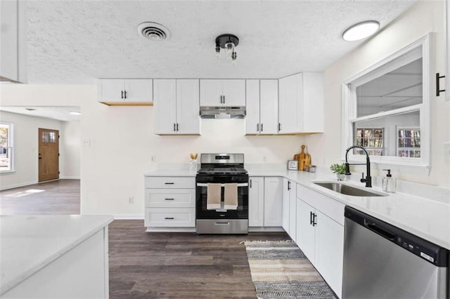 kitchen featuring sink, stainless steel appliances, dark hardwood / wood-style flooring, and white cabinets