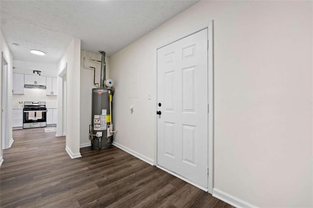 interior space featuring a textured ceiling, dark wood-type flooring, and gas water heater