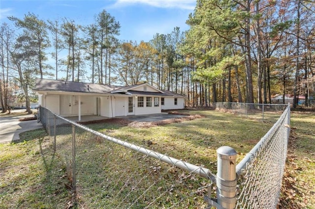 rear view of house featuring a yard