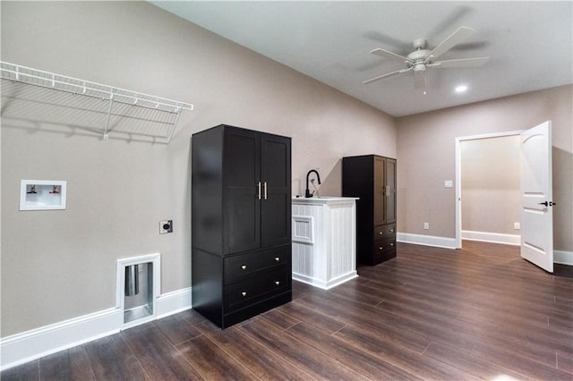 interior space featuring washer hookup, dark wood finished floors, ceiling fan, electric dryer hookup, and baseboards