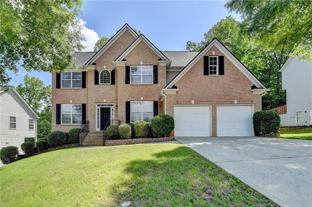 3805 Roxwood Park Dr, Buford, GA 30518 - colonial house featuring brick siding, concrete driveway, a front lawn, and an attached garage