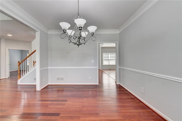 3805 Roxwood Park Dr, Buford, GA 30518 - unfurnished dining area featuring a chandelier, crown molding, wood finished floors, stairs, and baseboards