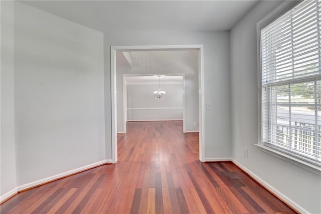 3805 Roxwood Park Dr, Buford, GA 30518 - hallway with a chandelier, wood finished floors, and baseboards