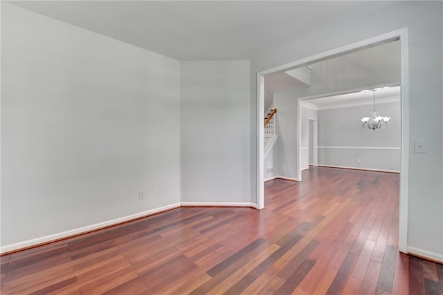 3805 Roxwood Park Dr, Buford, GA 30518 - unfurnished room featuring a chandelier, stairway, wood finished floors, and baseboards