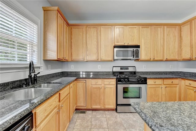 3805 Roxwood Park Dr, Buford, GA 30518 - kitchen featuring appliances with stainless steel finishes, a sink, dark stone countertops, light tile patterned floors, and light brown cabinets