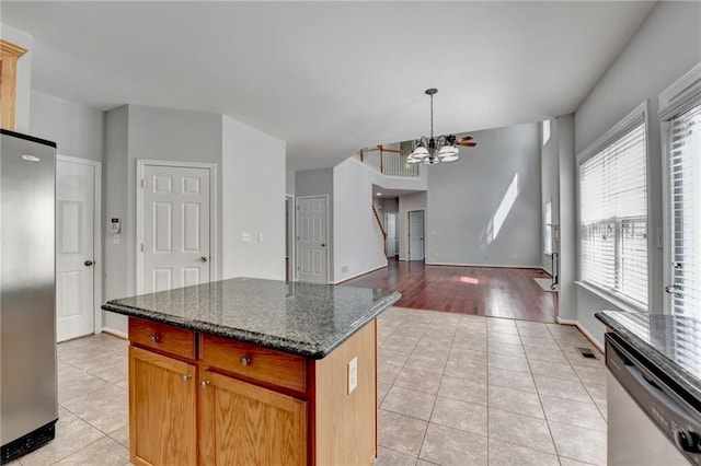 3805 Roxwood Park Dr, Buford, GA 30518 - kitchen with appliances with stainless steel finishes, light tile patterned floors, a chandelier, and a center island