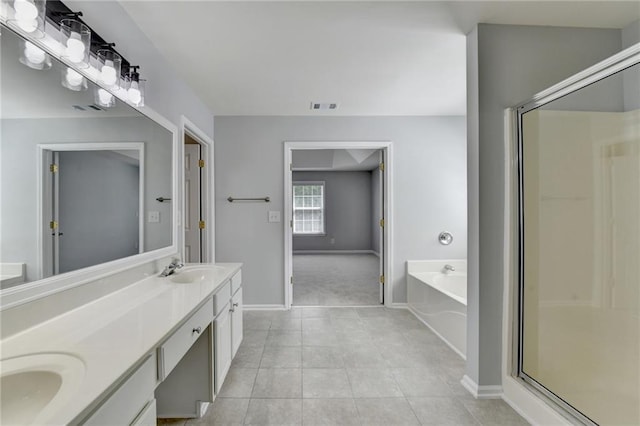 3805 Roxwood Park Dr, Buford, GA 30518 - full bathroom featuring a garden tub, double vanity, a shower stall, baseboards, and tile patterned flooring