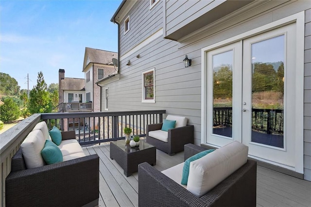 wooden terrace featuring french doors and outdoor lounge area