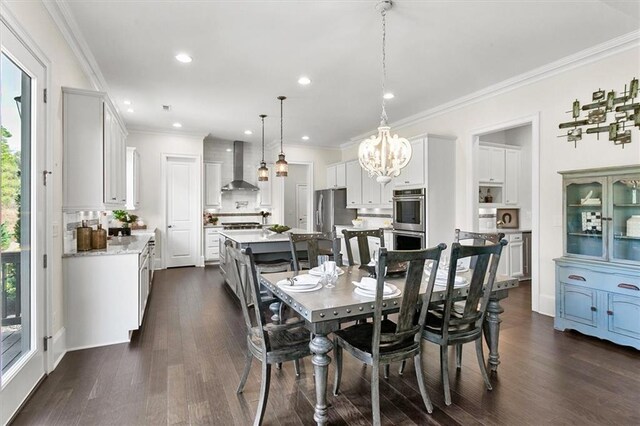 dining room with dark wood-type flooring, crown molding, and a chandelier