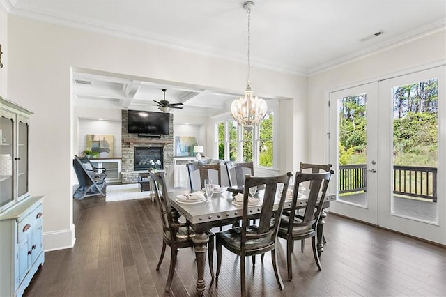 dining area with coffered ceiling, a fireplace, plenty of natural light, and beamed ceiling