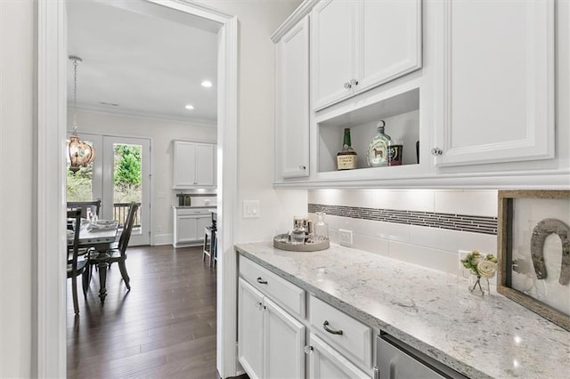 bar featuring white cabinetry, light stone counters, ornamental molding, decorative backsplash, and dark hardwood / wood-style flooring