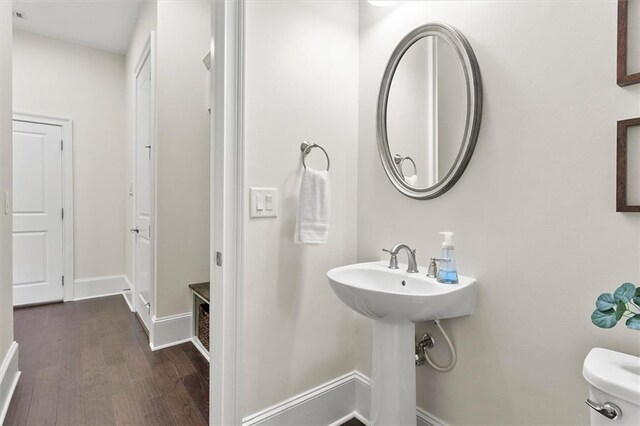 bathroom with toilet and hardwood / wood-style flooring