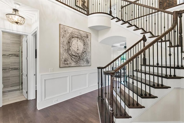 stairs with a chandelier and wood-type flooring