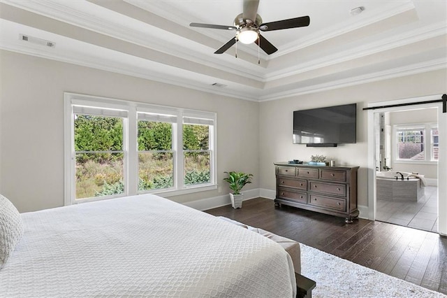 bedroom with a raised ceiling, ceiling fan, ornamental molding, a barn door, and dark hardwood / wood-style flooring