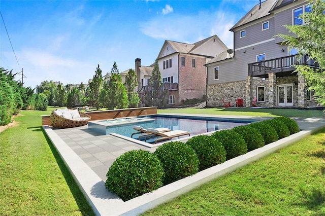 view of pool with french doors, a yard, an in ground hot tub, and a patio area