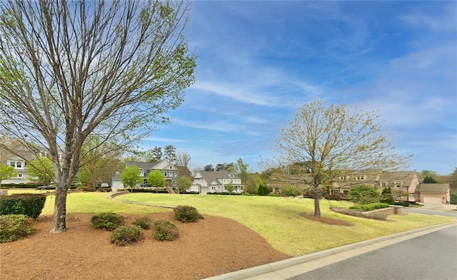 view of property's community with a lawn