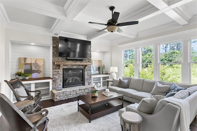 living room featuring coffered ceiling, ceiling fan, a fireplace, hardwood / wood-style flooring, and beam ceiling