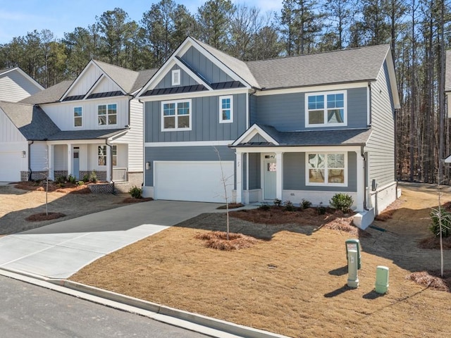 craftsman-style home with driveway, an attached garage, a shingled roof, and board and batten siding