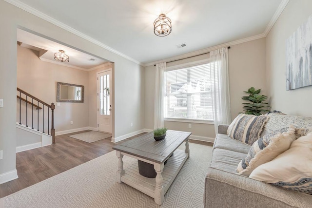 living room with hardwood / wood-style floors and crown molding