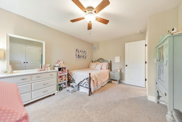 carpeted bedroom featuring a closet and ceiling fan