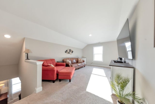 carpeted living room with vaulted ceiling