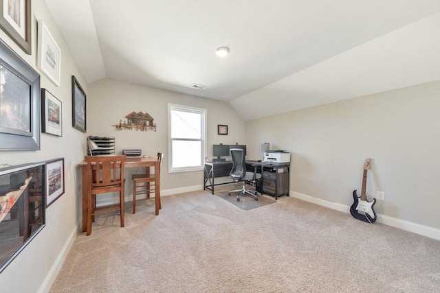 carpeted office space featuring vaulted ceiling