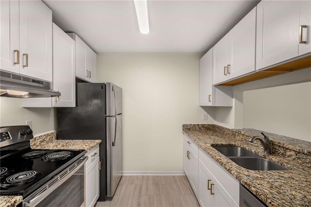 3655 Habersham Rd NE Unit 203, Atlanta, GA 30305 - kitchen with stainless steel appliances, under cabinet range hood, a sink, baseboards, and dark stone countertops