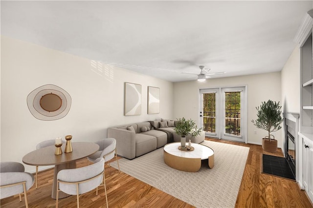 3655 Habersham Rd NE Unit 203, Atlanta, GA 30305 - living room featuring a ceiling fan, wood finished floors, a fireplace with flush hearth, and baseboards