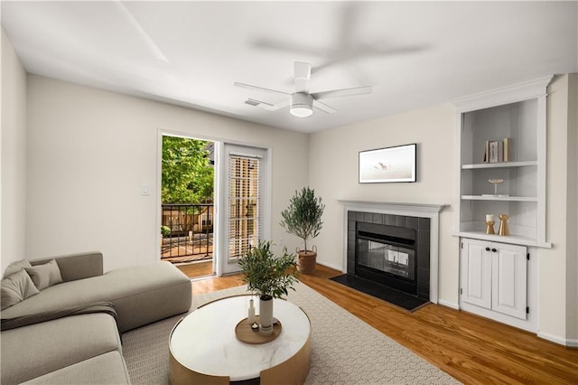3655 Habersham Rd NE Unit 203, Atlanta, GA 30305 - living area featuring light wood-style floors, a fireplace, and a ceiling fan