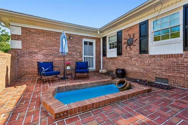 exterior space featuring a jacuzzi and a patio