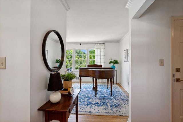 interior space with wood-type flooring and ornamental molding