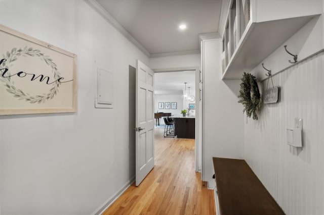 hallway with crown molding and light wood-type flooring