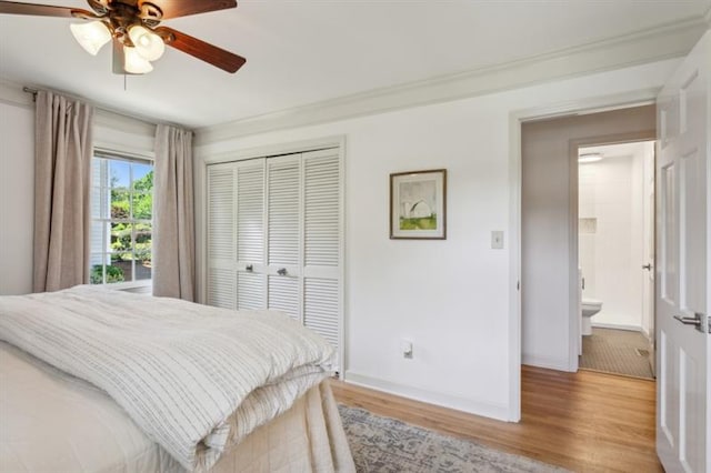 bedroom featuring ceiling fan, light hardwood / wood-style floors, and a closet