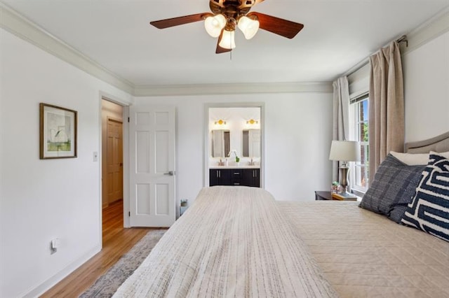 bedroom featuring connected bathroom, crown molding, light hardwood / wood-style floors, and ceiling fan