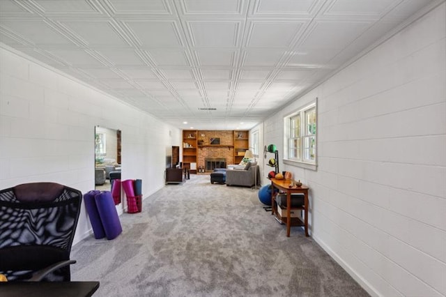 carpeted living room featuring a large fireplace