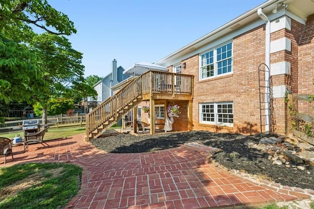 rear view of house featuring a patio and a deck