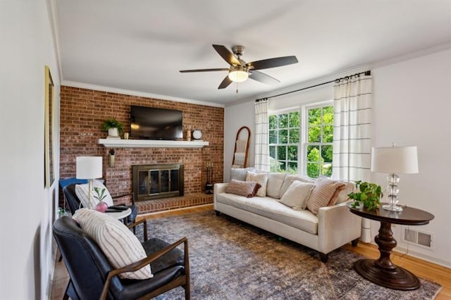 living room with crown molding, dark hardwood / wood-style floors, and a fireplace