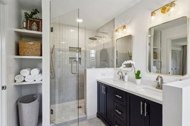 bathroom featuring vanity, a shower with shower door, and built in features