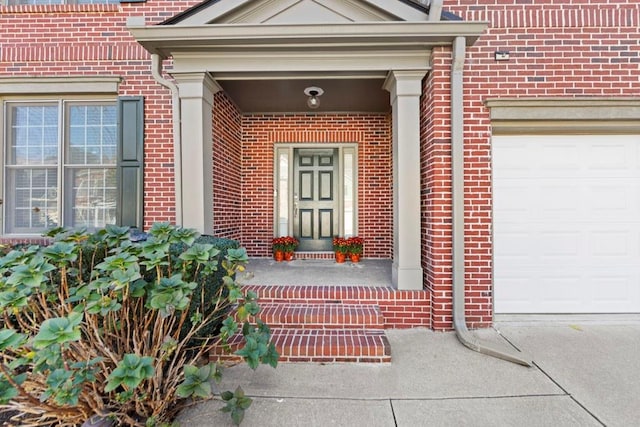 view of exterior entry with a garage