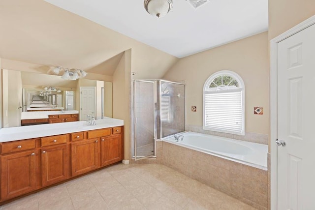 bathroom featuring tile patterned flooring, vanity, independent shower and bath, and vaulted ceiling