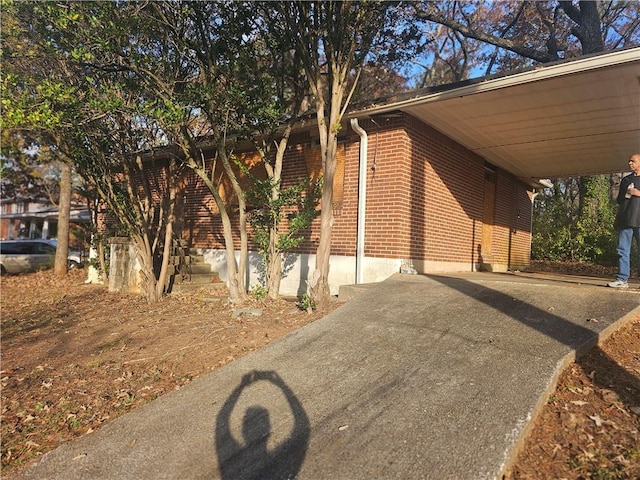 view of side of home with a carport