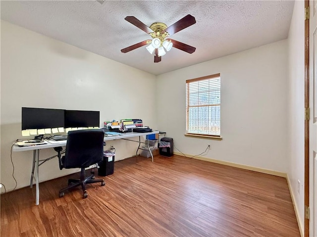 office featuring hardwood / wood-style flooring, ceiling fan, and a textured ceiling