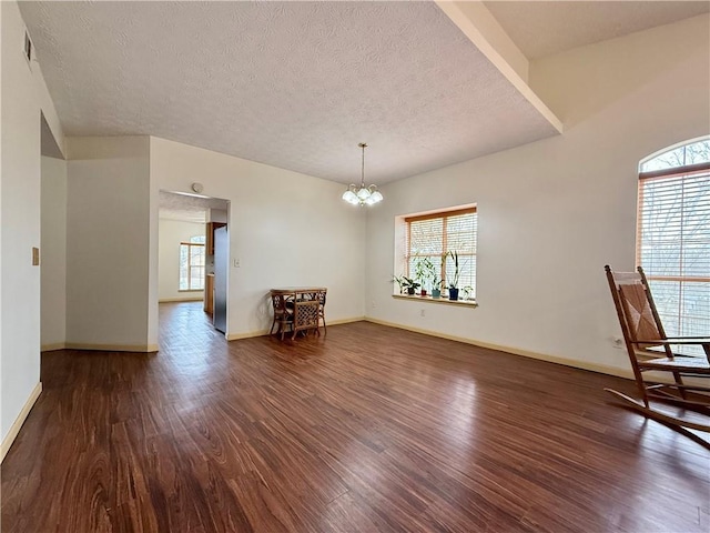 interior space with dark hardwood / wood-style floors and a healthy amount of sunlight