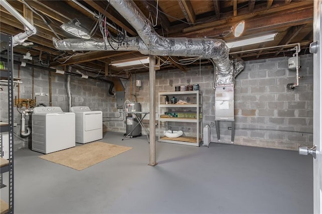 basement featuring independent washer and dryer and water heater